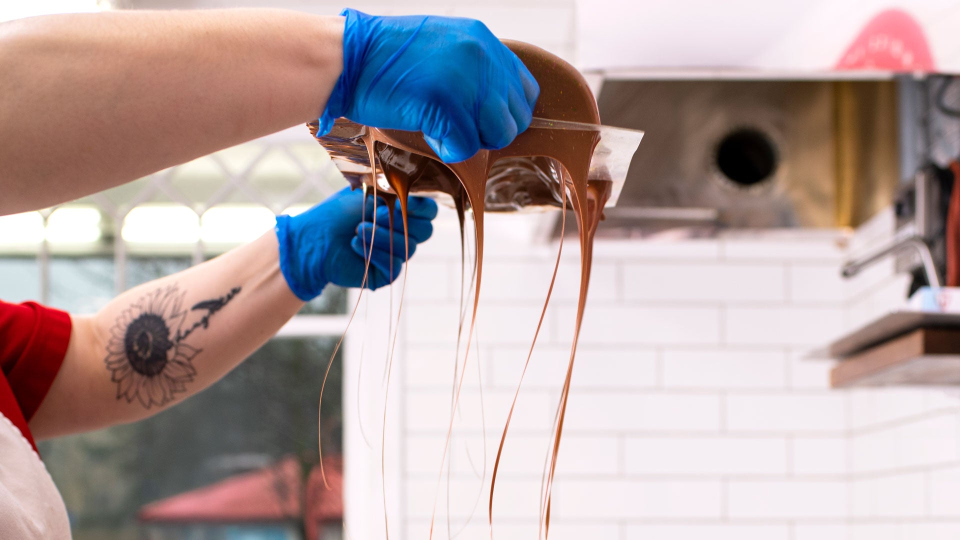 A chocolate maker hand-finishing a molded chocolate creation in the Frankenmuth kitchen